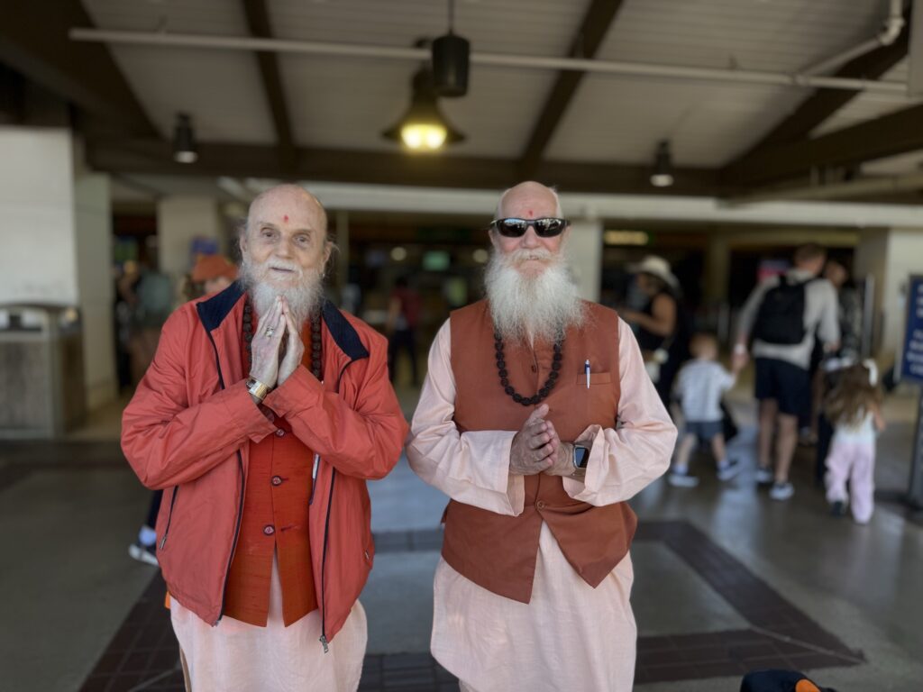 Satguru and Swami head to their plane at the Lihue airport